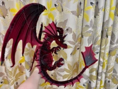 Red and gold handmade pipe cleaner dragon held in hand, buyer photo